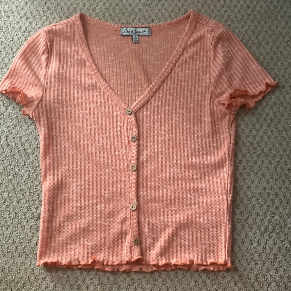 Peach colored shirt with buttons down the middle